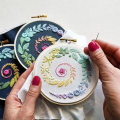 Jessica Long Embroidery hoop kit designed for adults with colorful floral patterns on navy fabric
