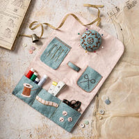Felt sewing kit with various tools on a textured surface. Designed by Corinne Lapierre. Available at tinypatio.com