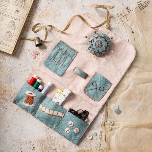 Felt sewing kit with various tools on a textured surface. Designed by Corinne Lapierre. Available at tinypatio.com