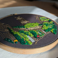 Close-up of the Circus Lane embroidery from the side, with the textured greenery catching the light