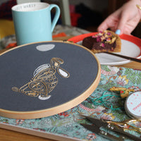 The finished hare hoop on a table set with a mug and a slice of cake